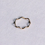 Gold stainless steel minimalist golf ring by Bazou featuring a sleek, modern design on a plain background.