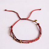 Viervuldige satijnen armband met kralen - bordeaux - Selva & Co
