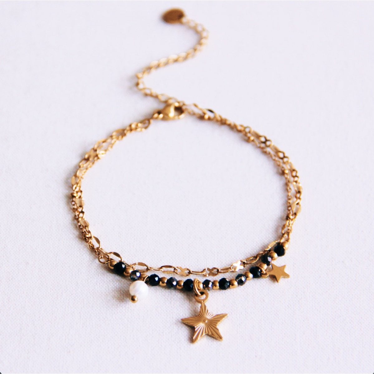 Roestvrijstalen dubbele armband met mini-facetten en ster - antraciet/goud - Selva & Co