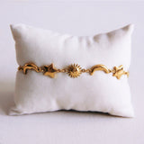 Schakelarmband met zon, maan en ster - goud - Selva & Co