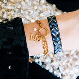 Dubbele schakelarmband met open hart - goud - Selva & Co