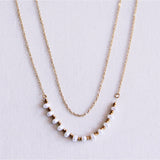Dubbele ketting met mini parels - goud/wit - Selva & Co