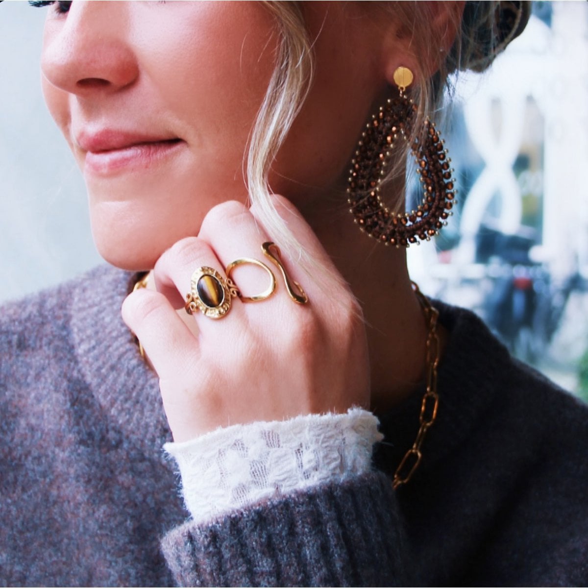 Bazou statement ring with oval brown gemstone, showcasing a bold design and warm earthy tones in a close-up image.