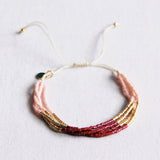 Bazou Viervoudige Miyuki armband in bordeaux, nude, and gold colors with intricate beaded design.