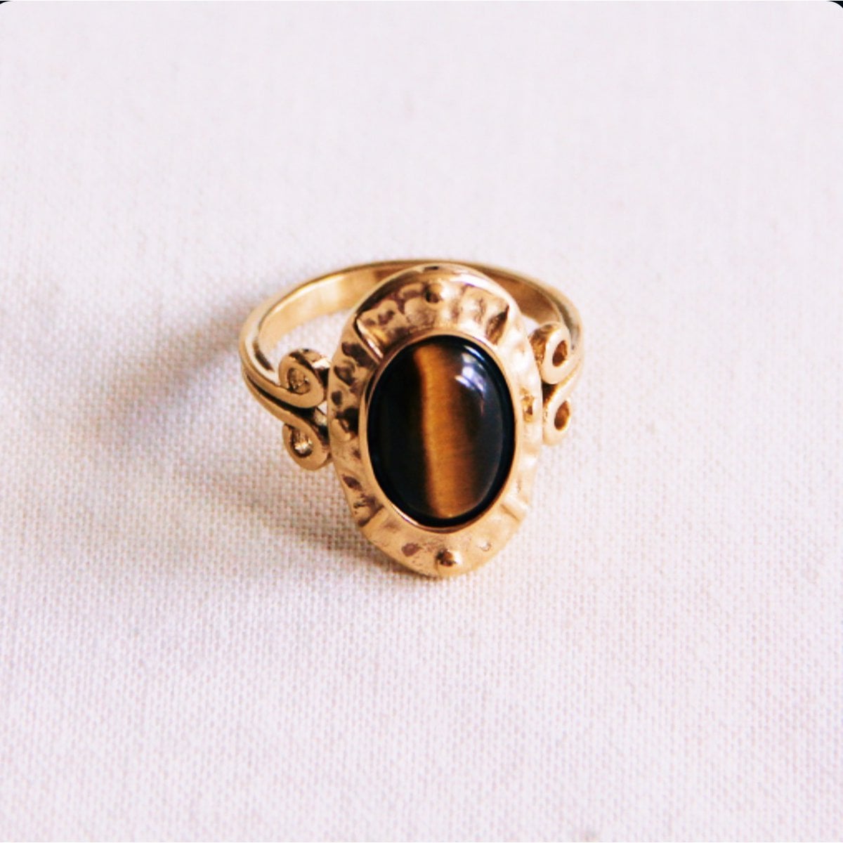 Bronze statement ring by Bazou featuring an oval brown stone, stylish and eye-catching jewelry piece.