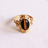 Bronze statement ring by Bazou featuring an oval brown stone, stylish and eye-catching jewelry piece.