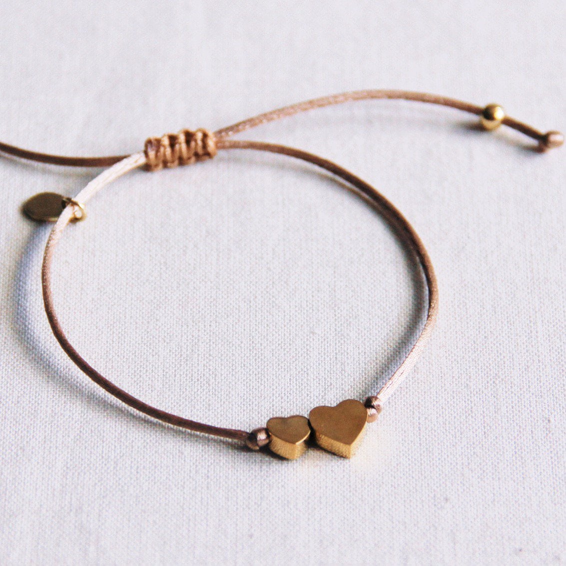 Satin bracelet with small and large heart - taupe / gold - Selva & Co