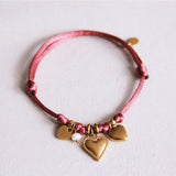 Satijnen armband met hartjes en kleine parel - roze - Selva & Co