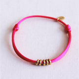 Satijnen armband met ringen – fuchsia/goud - Selva & Co
