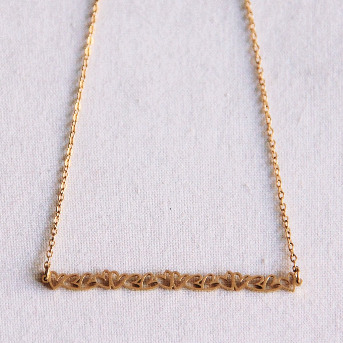 Fine necklace with a row of mini hearts - Selva & Co