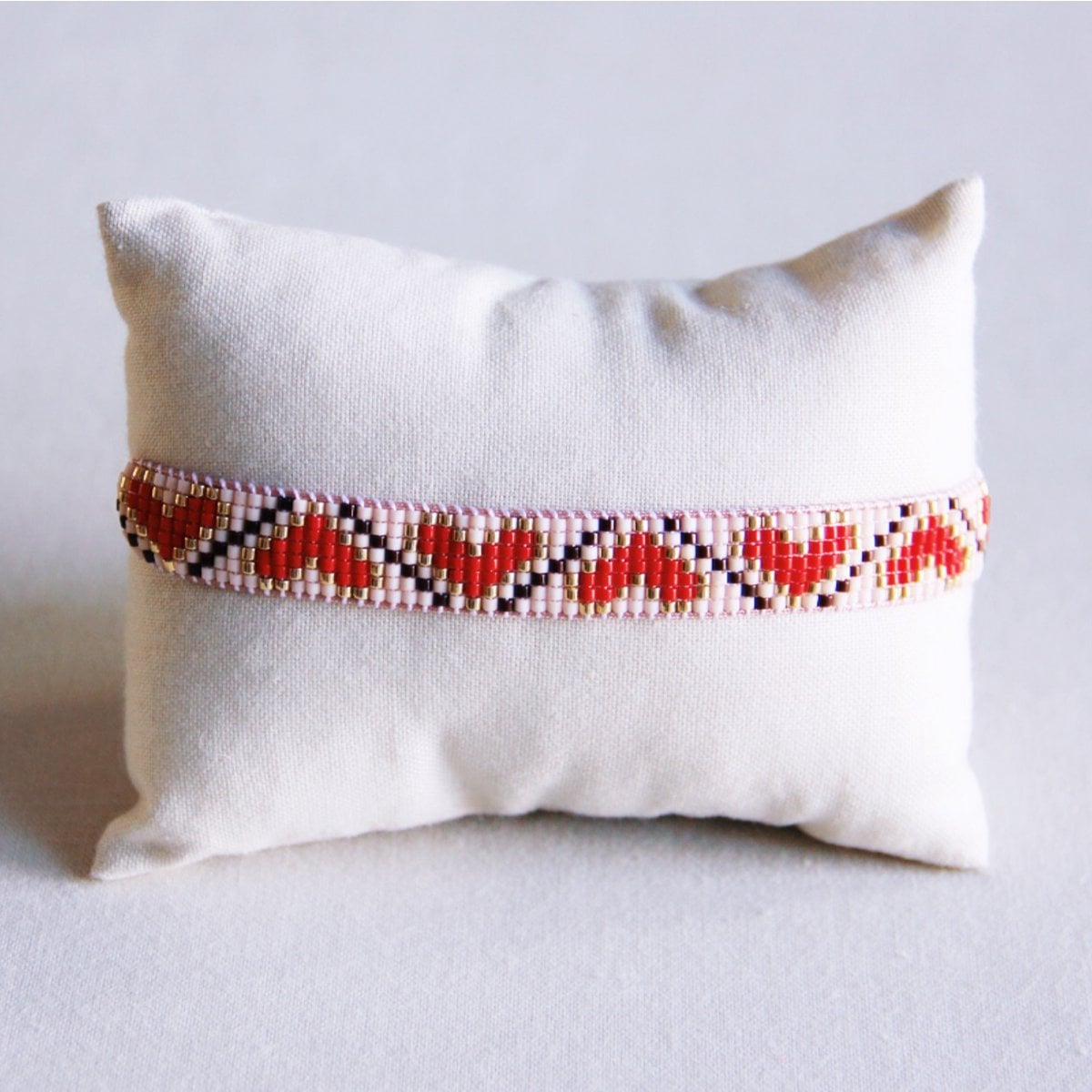 Red and brown Miyuki beaded armband with heart pattern from Bazou, featuring intricate beadwork and adjustable fit.