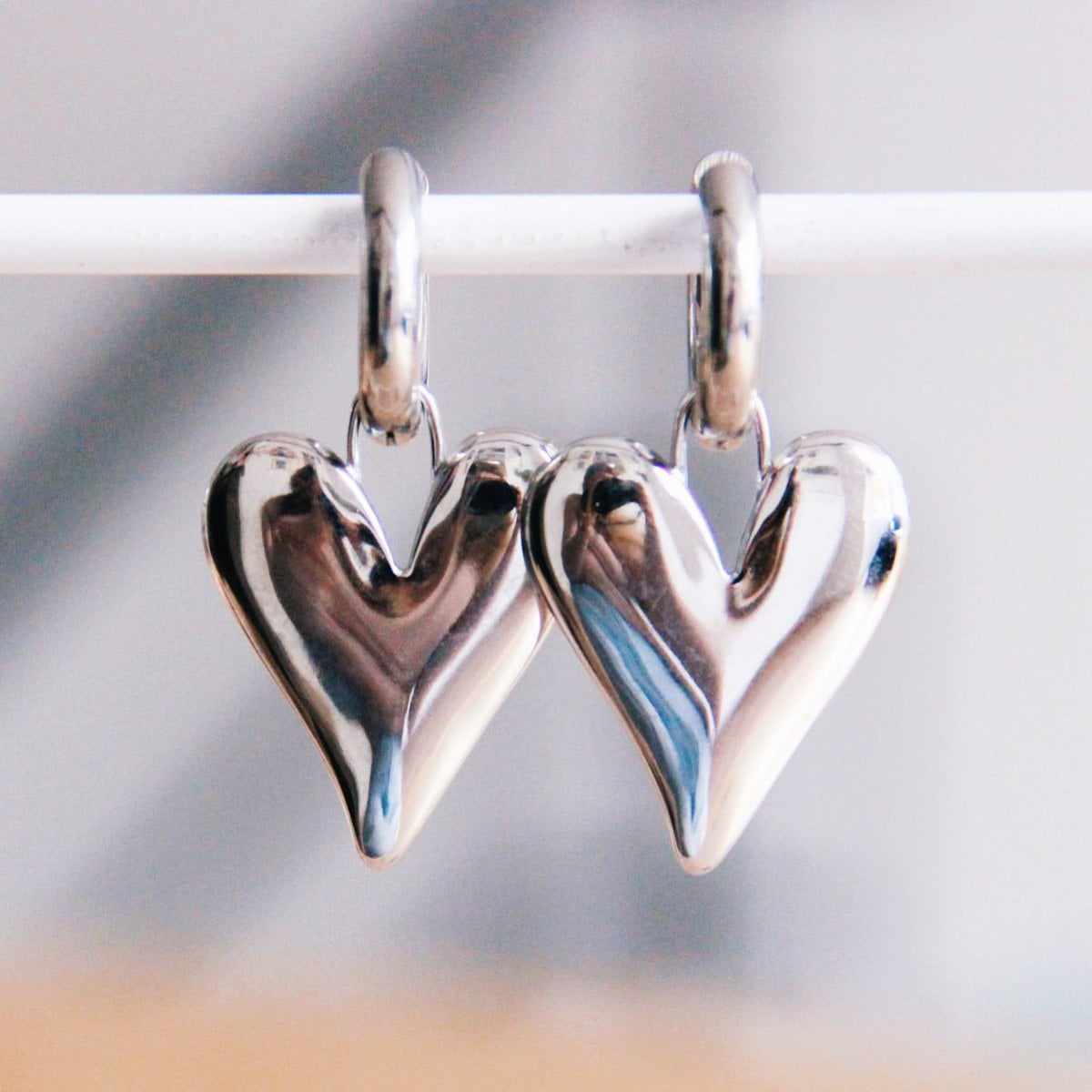 Stainless steel wide hoop earring with XL closed heart - silver - Selva & Co