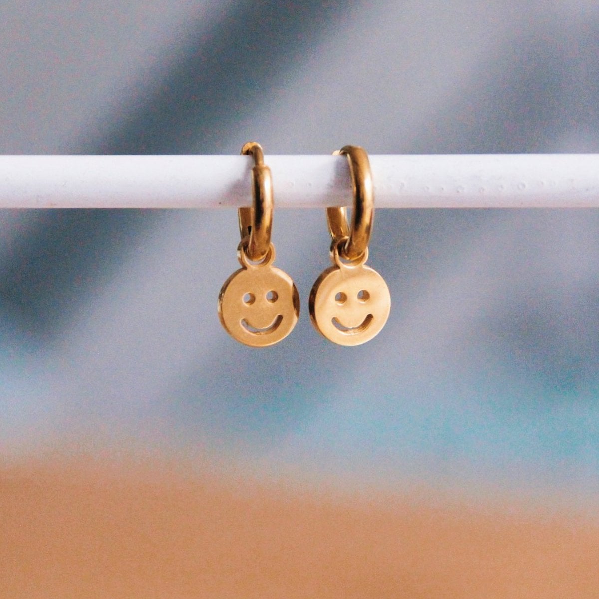 Stainless steel hoop earrings with smiley – gold - Selva & Co